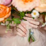 the bride has a blue charm on her bouquet