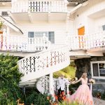 the couple walks excitedly down the white spiral stairs together