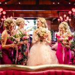 the bridesmaids stand with the bride, surrounded by the maximalist decor of Madonna Inn