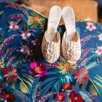 white wedding shoes on a colorful couch