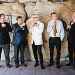 groomsmen and groom fixing their bowties