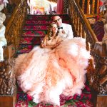 the couple closes their eyes and enjoys a moment on the stairs at Madonna Inn