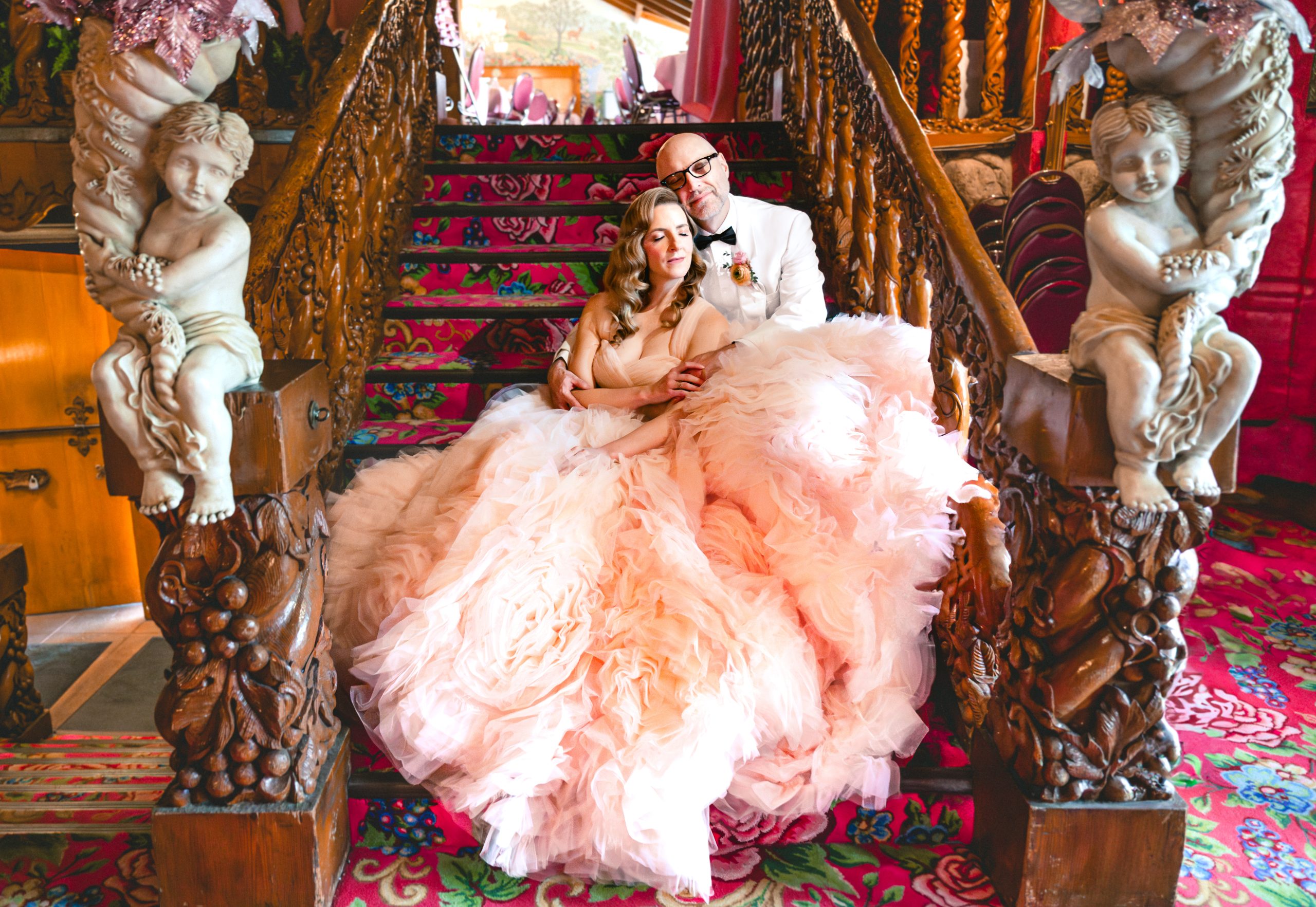 the couple closes their eyes and enjoys a moment on the stairs at Madonna Inn