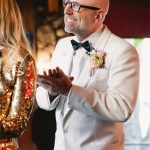 groom claps for the bride as she walks down the stairs