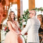 the couple holds hands and shares vows