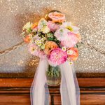 this bridal bouquet is filled with peonies and other beautiful colorful flowers
