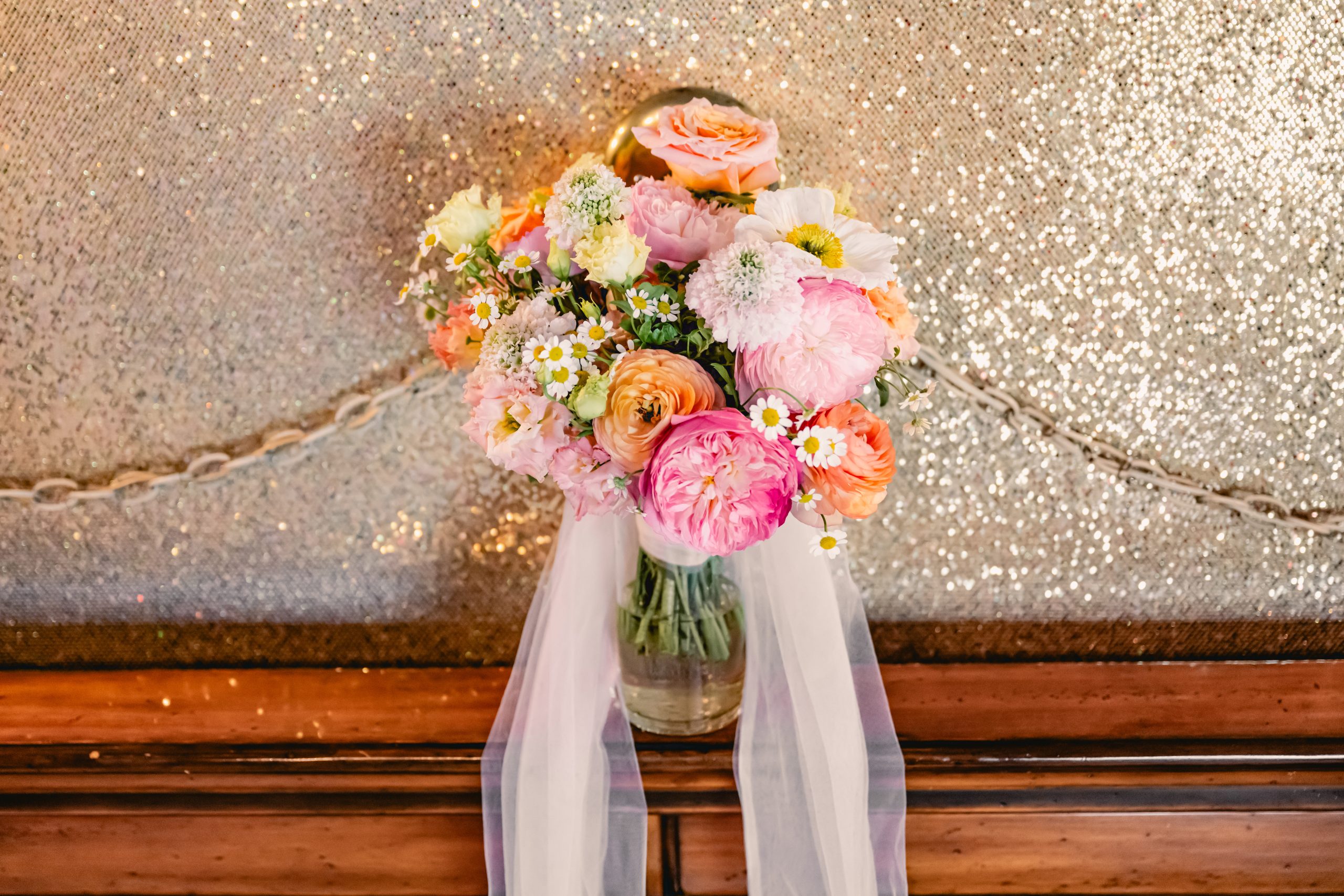 this bridal bouquet is filled with peonies and other beautiful colorful flowers