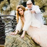 the bride and groom pretend they are tigers in a forest
