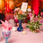 pink, red, blue florals, glass vases and vintage elements decorate the tables