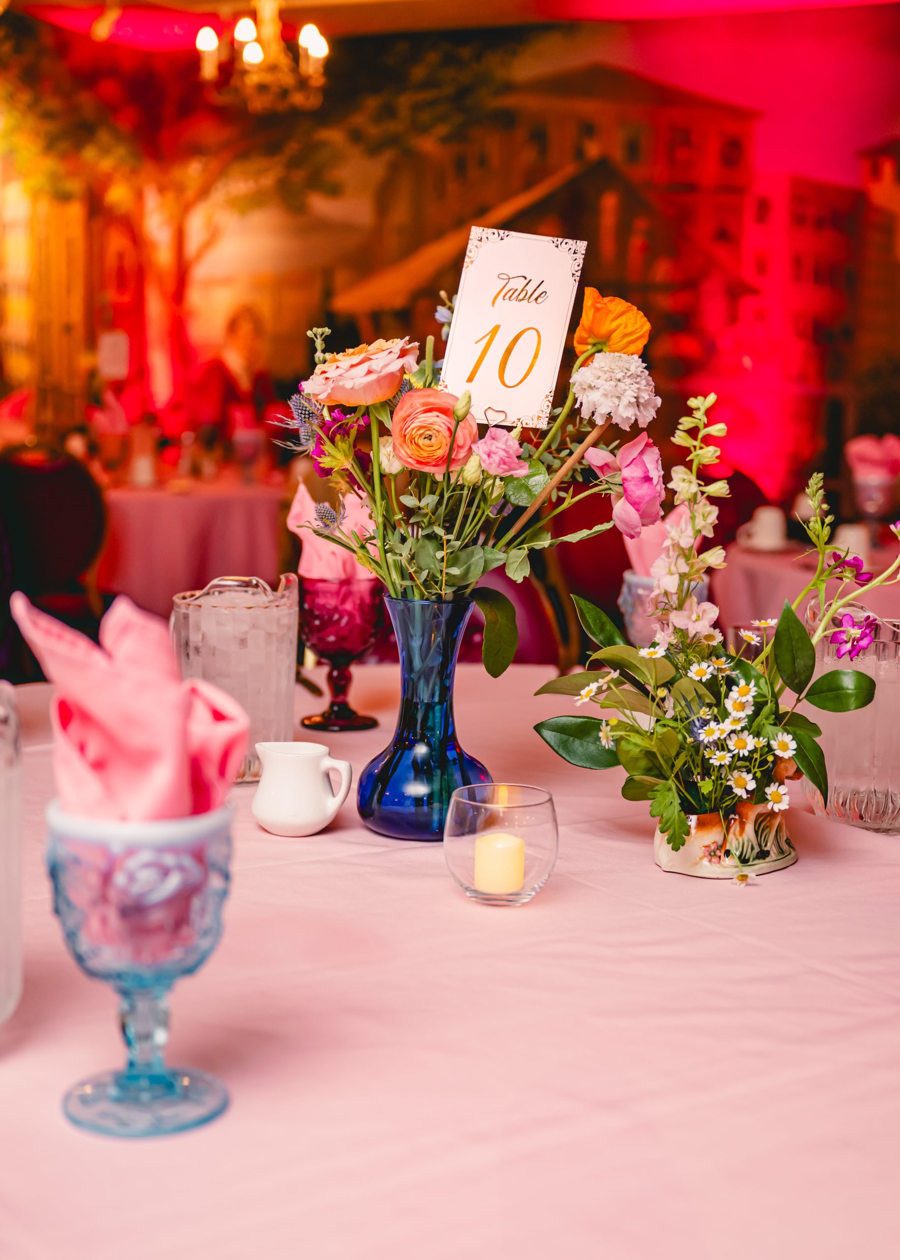 pink, red, blue florals, glass vases and vintage elements decorate the tables