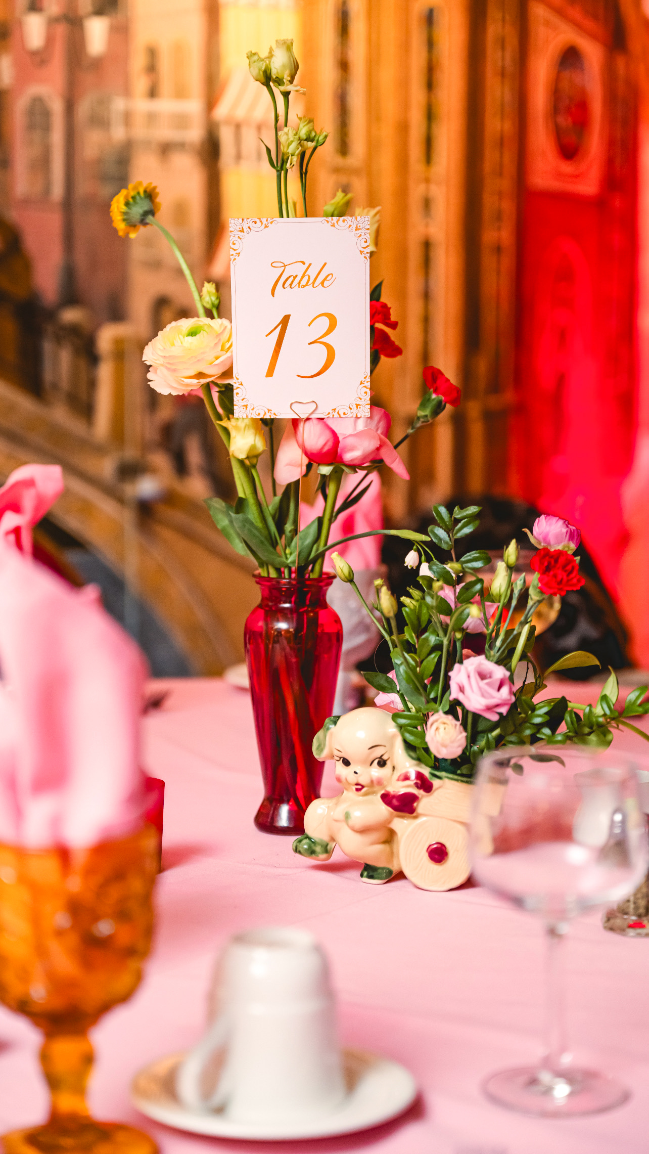 pink, red, blue florals, glass vases and vintage elements decorate the tables