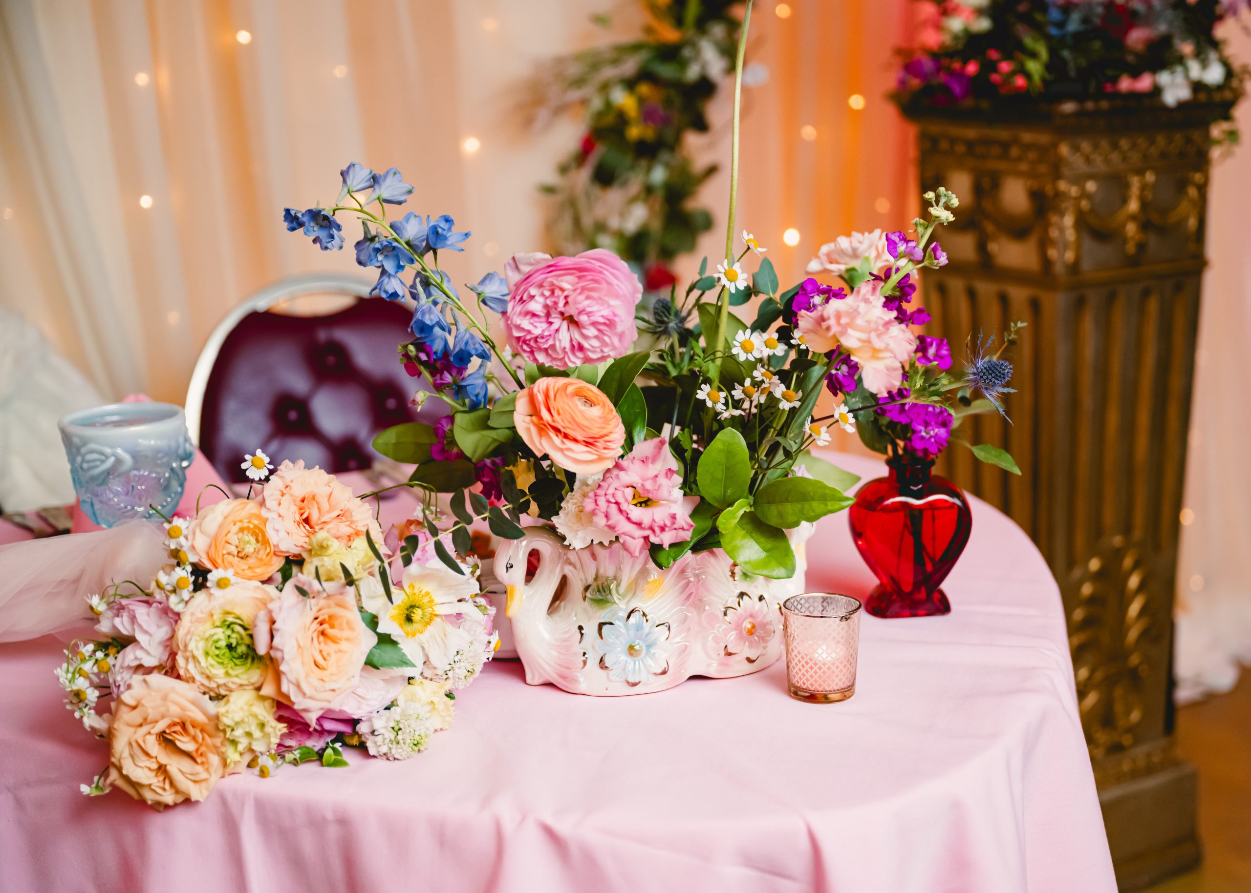 pink, red, blue florals, glass vases and vintage elements decorate the sweetheart table at madonna inn