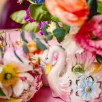 pink, red, blue florals, glass vases and vintage elements decorate the sweetheart table at madonna inn