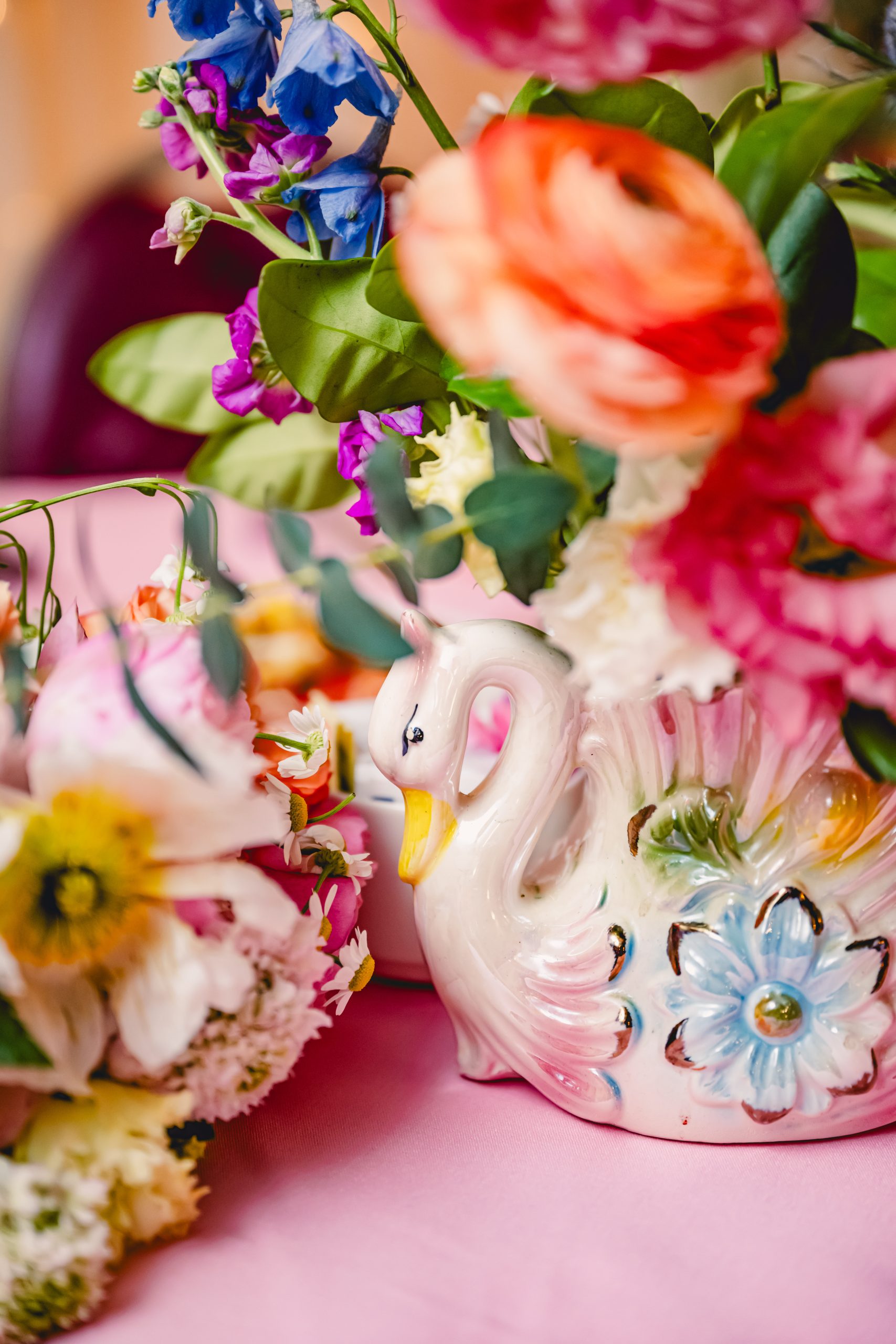 pink, red, blue florals, glass vases and vintage elements decorate the sweetheart table at madonna inn