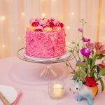 the pink champagne cake is a pink frosting covered vanilla filled masterpiece only found at Madonna Inn