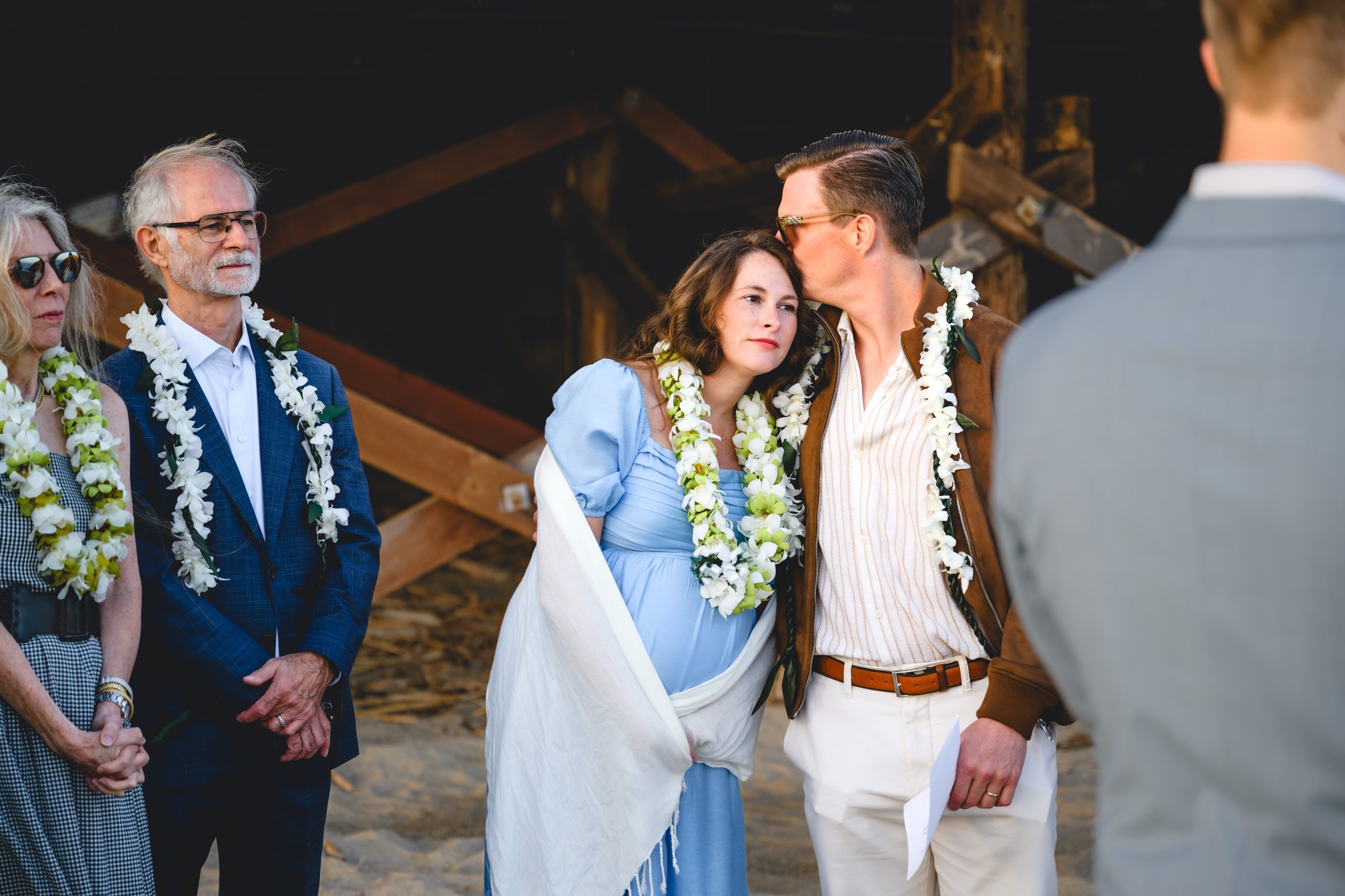 wedding guests enjoy the ceremony and hold onto each other happily