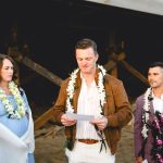 a wedding guest shares a reading during this beach ceremony