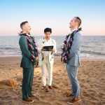 the sun sets over the ocean in malibu during this two groom elopement ceremony