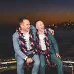 A gay couple enjoys their first moments of marriage at twilight in malibu